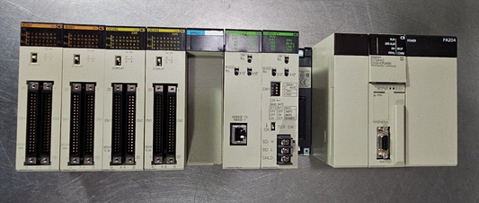 OMRON CS1W-BC083 / CS1G-CPU45H / PA204/ CLK21-V1 / ETN21 / OD262 / ID261.  3A-23