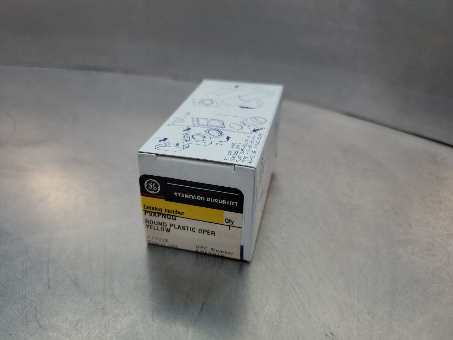 GE P9XPNGG YELLOW ROUND PLASTIC STANDARD PUSH BUTTON OPERATOR.              4A-3